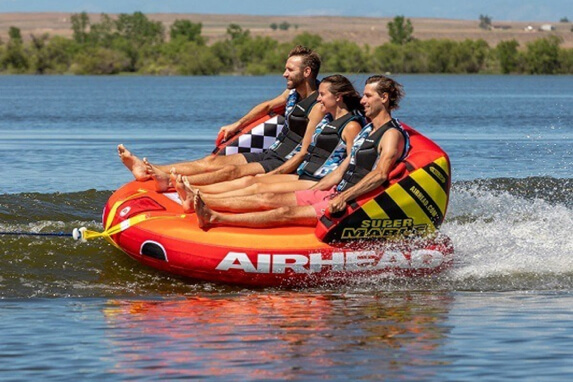 Three riders laughing on Airhead Super Mable towable