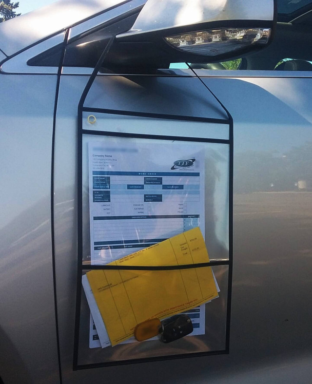 Double-pocket auto repair order holder hanging from vehicle mirror with work order and supporting documents
