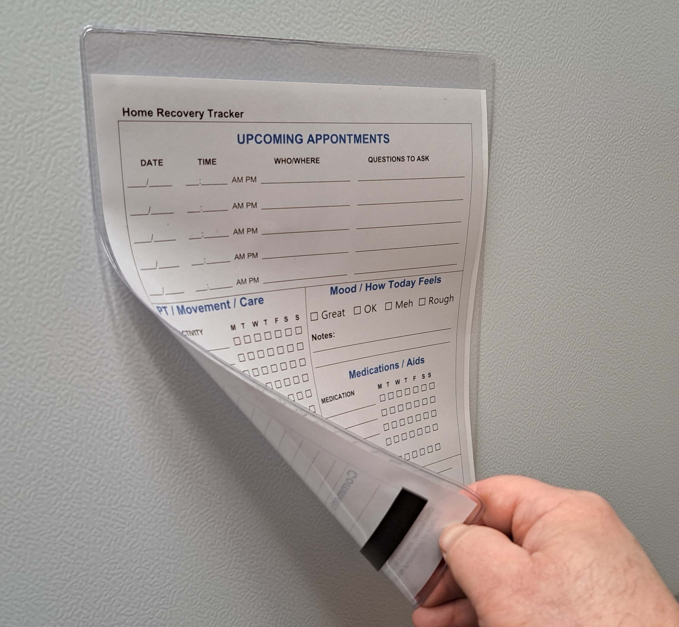 Clear magnetic heat welded clear vinyl holder ssleeve mounted on a white steel surface with dry marker erase home medical care sheet inside