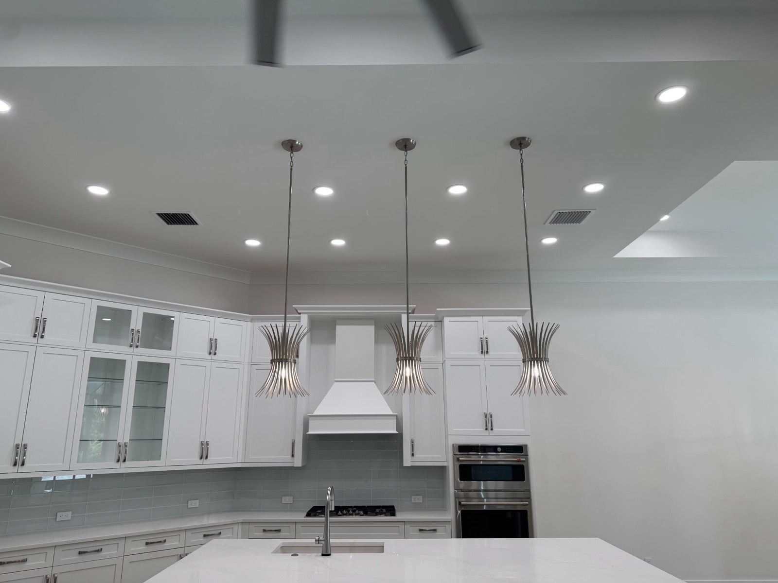 kitchen hanging lights in a white modern kitchen