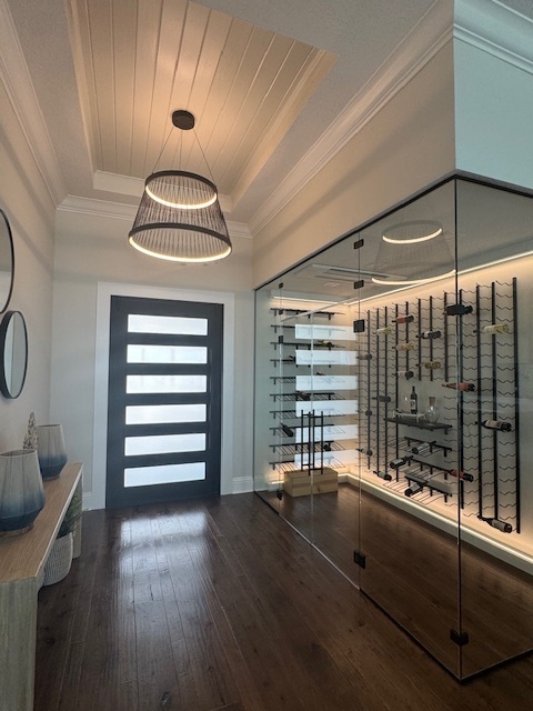 a glass wine cellar next to an entryway