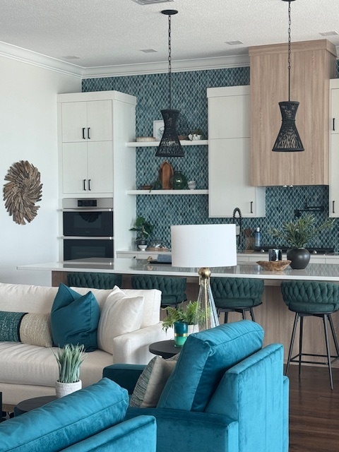 clean kitchen with hanging wire frame lights and teal furniture