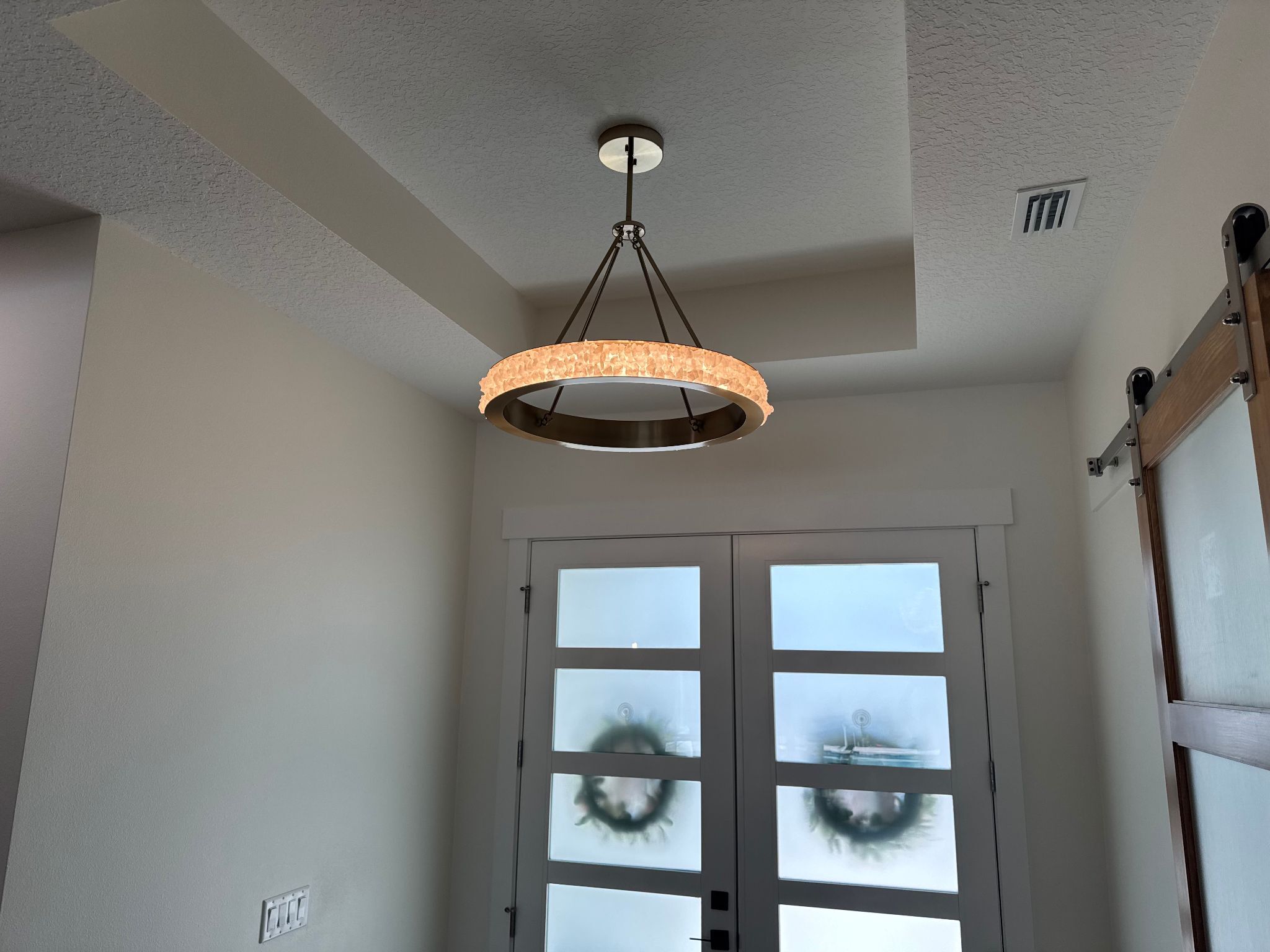 ring shaped chandelier in entryway 