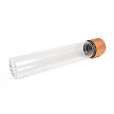 glass pre roll tubes tilted with a rose gold cap at the upper right and a clear rounded base