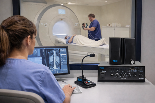 Technologist controls music into patient headphones