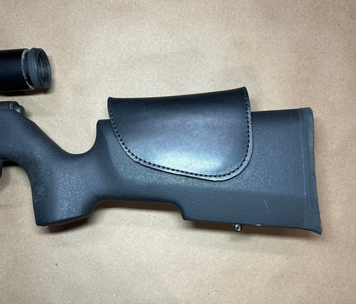 This shows our Leather Cheek Riser on a Savage MK11 .22 rifle with a Nikon scope. it is adjusted to fit me even with low scope rings.