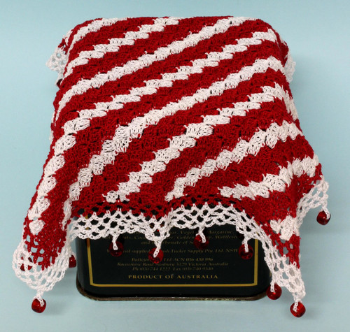 Crocheted jug cover, worked from corner to corner.