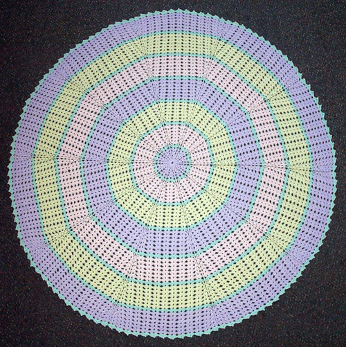 Image of finished baby shawl from Craft Moods book BK34 Pattern 3 Circular Shawl with relief stitch.