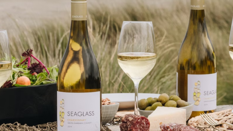 People enjoying picnic with wine at the beach