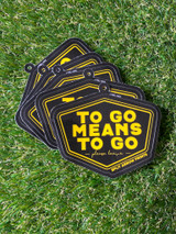 tag stickers for "to go means to go " shirts in a fanned out formation showing the consistency. Tag sticker is coated in matte silk lamination.