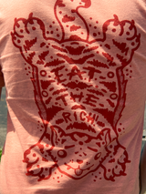 Detailed view of tibetan tiger rug design on back of Eat the Rich tee