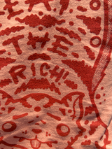 Upclose detail shot of Tibetan tiger rug on Eat the Rich Tee, shows orange ink vibrancy on garment