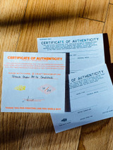 a selection of style of certificate one being more simple printed in orange and one more advanced printed in teal