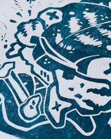 Image featuring a one color art print using teal ink with a grass background. Image is an up close angle of a illustrated tiger head