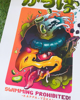 Product image of a Poster featuring a Kappa Japanese Yokai monster. Poster Features a monster with a yellow beak, blue hair, and water with pickles and Japanese writing at the top. Translates to "Kappa" Image is brightly colored with pinks, oranges, yellows, greens. Poster is on a grass background
