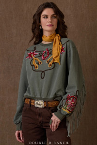 WHO SAYS A SWEATSHIRT CAN’T BE CHIC?
Casual comfort takes a turn toward couture in this extraordinary sweatshirt. The classic cotton top is alluring in an olive green, embellished with bold embroidery of Western icons – a pair of spurs, a horseshoe, and a colorful wagon wheel. It’s finished with tonal fringe that spans from cuff to cuff and across the back. It’s easy to wear and effortlessly awesome.
color: olive
content: 100% cotton
embellishments: fringe, ribbing to match, embroidery
fit: Loose fit, high hip length
style number: T4098
collection: Atomic Ranch WHO SAYS A SWEATSHIRT CAN’T BE CHIC?
Casual comfort takes a turn toward couture in this extraordinary sweatshirt. The classic cotton top is alluring in an olive green, embellished with bold embroidery of Western icons – a pair of spurs, a horseshoe, and a colorful wagon wheel. It’s finished with tonal fringe that spans from cuff to cuff and across the back. It’s easy to wear and effortlessly awesome.
color: olive
content: 100% cotton
embellishments: fringe, ribbing to match, embroidery
fit: Loose fit, high hip length
style number: T4098
collection: Atomic Ranch