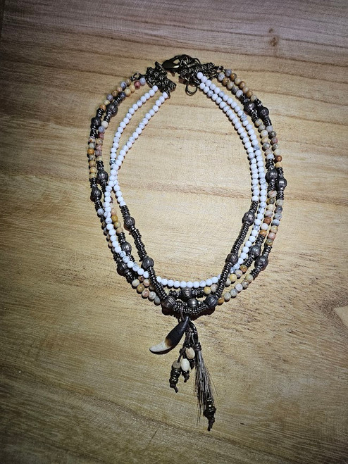 4 strand necklace with assorted metal, stone and howlite beads
Bohemian charm on one 1 strand with dangling beads, animal tooth and horse hair
17 inch adjustable brass chain 