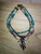 4 strand necklace with assorted metal, stone and turquoise beads
Bohemian charm on one 1 strand with dangling beads, animal tooth and horse hair
17 inch adjustable brass chain 