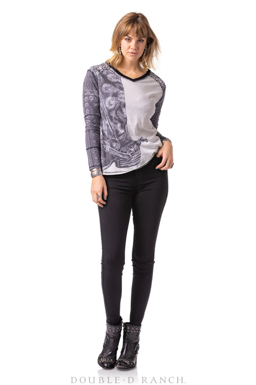 GRAPHIC TEE GONE “WILD”.
 You’re going to love this tonal top featuring an off-center, oversized iteration of a spurred up cowboy boot, accompanied by bandana-style patterned long sleeves, contrast stitching, and a chic shallow V-neck collar.

color: silver spur
content: 75% poly, 25% rayon
embellishments: printing
size: S,M,L
fit: relaxed
style number: T3577
collection: Wild Horses
in stock