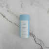 Unscented Zero-Waste 3-ounce Vegan Deodorant Tube in blue on a white marble countertop background