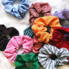 A pile of multiple different colors of upcycled scrunchies