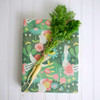 A gift wrapped in compostable and reversible enchanted garden wrapping paper