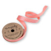 A cardboard spool of coral 100% cotton curling ribbon