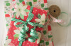 A red gift wrapped in green and white stripped 100% cotton curling ribbon