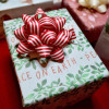 Red and White Striped Sustainable Cotton Gift Bow placed on a Christmas Basket