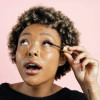 A woman applying Zero-Waste Mascara to her eyelashes