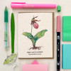 A greeting card with a watercolor lady's slipper flower design on wildflower plantable seed paper