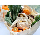An open Multi-Pocket Organic Cotton Tote Bag full of veggies from an aerial side view on a white marble counter