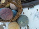 Multiple wool dryer balls in earthy tones in a basket