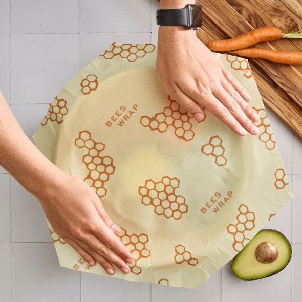 Large reusable bowl cover being put on a large bowl