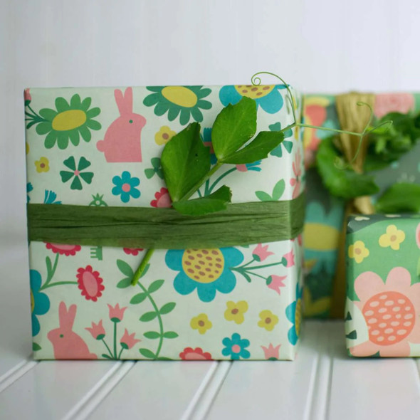 Multiple gifts wrapped in compostable and reversible enchanted garden wrapping paper