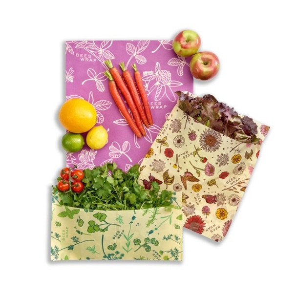 Gardner's bundle gift pack of reusable beeswax food wraps with veggies in them on white background