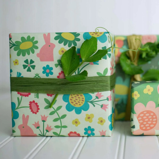 Multiple gifts wrapped in compostable and reversible enchanted garden wrapping paper