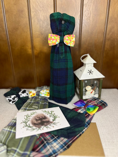 A green plaid upcycled wine bottle gift bag on bottle with a flowery bow