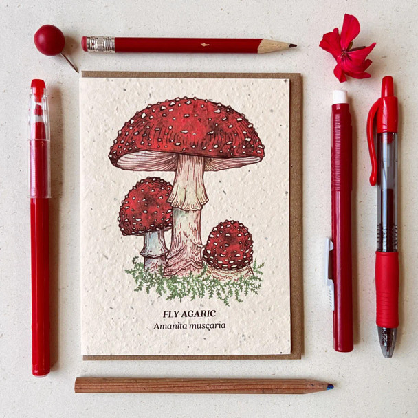 A greeting card with a watercolor mushroom design on wildflower plantable seed paper