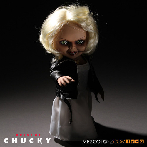 Child's Play - Tiffany 15" Talking Action Figure

First introduced in the film Bride Of Chucky, Tiffany was the devoted girlfriend of killer Charles Lee Ray before his soul transferred into the 'Good Guy' doll that would come to be known as Chucky. After Chucky ended up in a police evidence vault, Tiffany used her feminine wiles to rescue him. When Chucky electrocutes her in a bathtub, he transfers her soul into a bridal doll. Now trapped in a doll body, Tiffany joins Chucky on his quest to find the Heart of Damballa, the amulet that can transfer their souls into human bodies.

Tiffany is perfectly screen-matched from her bleached-blond hair to her black work boots. Dressed in her bridal gown with "leather" jacket, she comes complete with her TIFF necklace, tattooed d?colletage, and lacquered fingernails.

Just as verbose as she was in Bride Of Chucky, Tiffany has lots to say. She speaks six phrases direct from the film, activated by a discrete button on her back. Tiffany also features realistic glass-like eyes and nine points of articulation.

Tiffany comes packaged in her own collector-friendly window box perfect for display.

696198780154