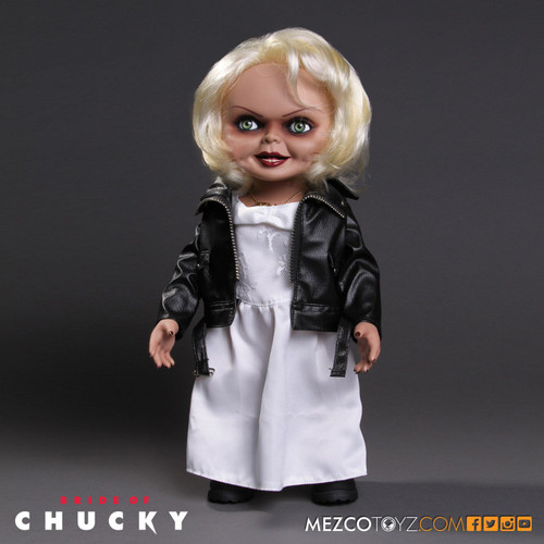 Child's Play - Tiffany 15" Talking Action Figure

First introduced in the film Bride Of Chucky, Tiffany was the devoted girlfriend of killer Charles Lee Ray before his soul transferred into the 'Good Guy' doll that would come to be known as Chucky. After Chucky ended up in a police evidence vault, Tiffany used her feminine wiles to rescue him. When Chucky electrocutes her in a bathtub, he transfers her soul into a bridal doll. Now trapped in a doll body, Tiffany joins Chucky on his quest to find the Heart of Damballa, the amulet that can transfer their souls into human bodies.

Tiffany is perfectly screen-matched from her bleached-blond hair to her black work boots. Dressed in her bridal gown with "leather" jacket, she comes complete with her TIFF necklace, tattooed d?colletage, and lacquered fingernails.

Just as verbose as she was in Bride Of Chucky, Tiffany has lots to say. She speaks six phrases direct from the film, activated by a discrete button on her back. Tiffany also features realistic glass-like eyes and nine points of articulation.

Tiffany comes packaged in her own collector-friendly window box perfect for display.

696198780154