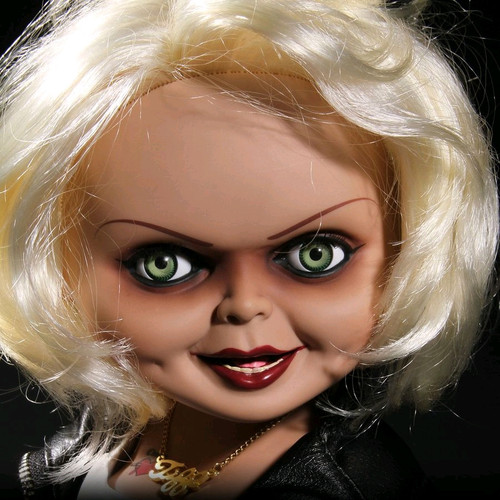 Child's Play - Tiffany 15" Talking Action Figure

First introduced in the film Bride Of Chucky, Tiffany was the devoted girlfriend of killer Charles Lee Ray before his soul transferred into the 'Good Guy' doll that would come to be known as Chucky. After Chucky ended up in a police evidence vault, Tiffany used her feminine wiles to rescue him. When Chucky electrocutes her in a bathtub, he transfers her soul into a bridal doll. Now trapped in a doll body, Tiffany joins Chucky on his quest to find the Heart of Damballa, the amulet that can transfer their souls into human bodies.

Tiffany is perfectly screen-matched from her bleached-blond hair to her black work boots. Dressed in her bridal gown with "leather" jacket, she comes complete with her TIFF necklace, tattooed d?colletage, and lacquered fingernails.

Just as verbose as she was in Bride Of Chucky, Tiffany has lots to say. She speaks six phrases direct from the film, activated by a discrete button on her back. Tiffany also features realistic glass-like eyes and nine points of articulation.

Tiffany comes packaged in her own collector-friendly window box perfect for display.

696198780154