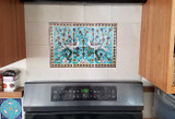 Light blue birds installed behind stove