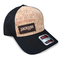black mesh trucker hat with cork front and black bill with dark brown jackson kayak leather patch logo, front black mesh trucker hat with cork front and black bill with dark brown jackson kayak leather patch logo, front