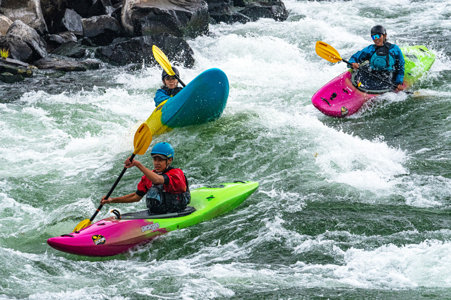 young paddler with their Jackson Kayak at the ready on the riverbank
