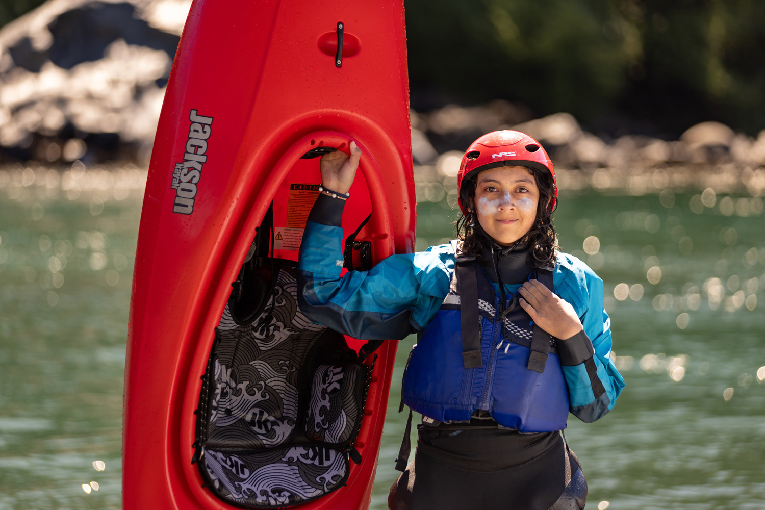two young paddlers in Jackson Kayaks forming a heart symbol with hands
