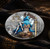 Angled view of the Themis coin showing the antiqued field and 24K gilded scales and sword
