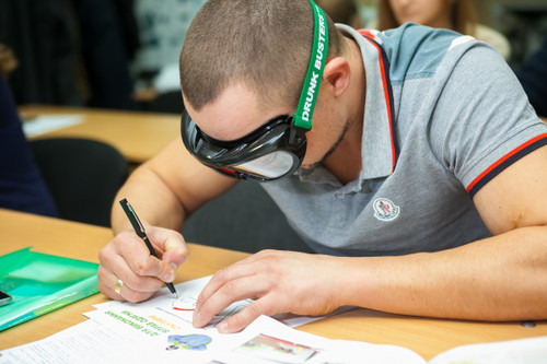 Doing homework while impaired by wearing a Drunk Busters Low Level BAC Goggle