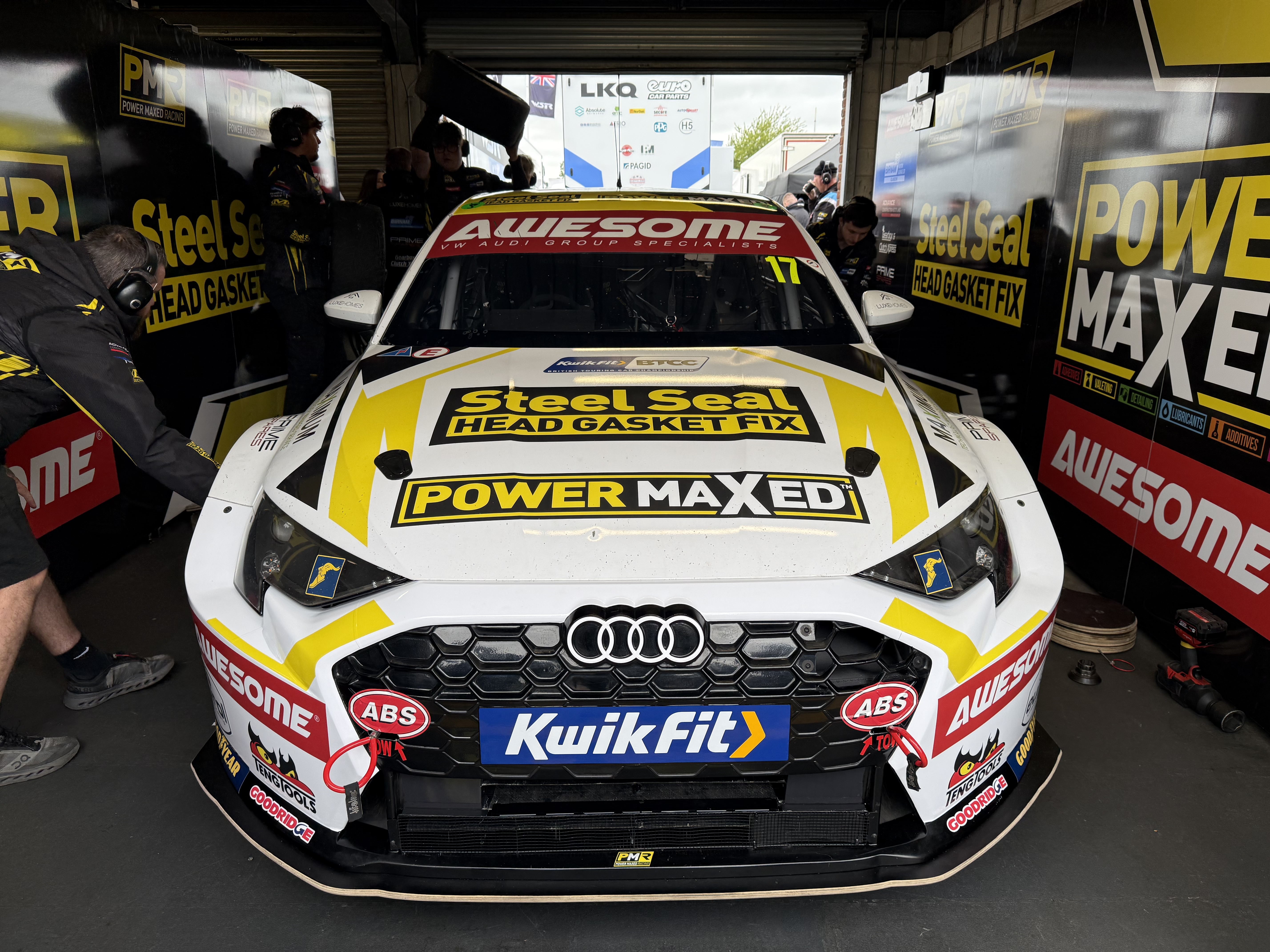 The Awesome-sponsored #17 Steel Seal Power Maxed Racing Audi S3 head-on in the Oulton Park garage as the team works on the car