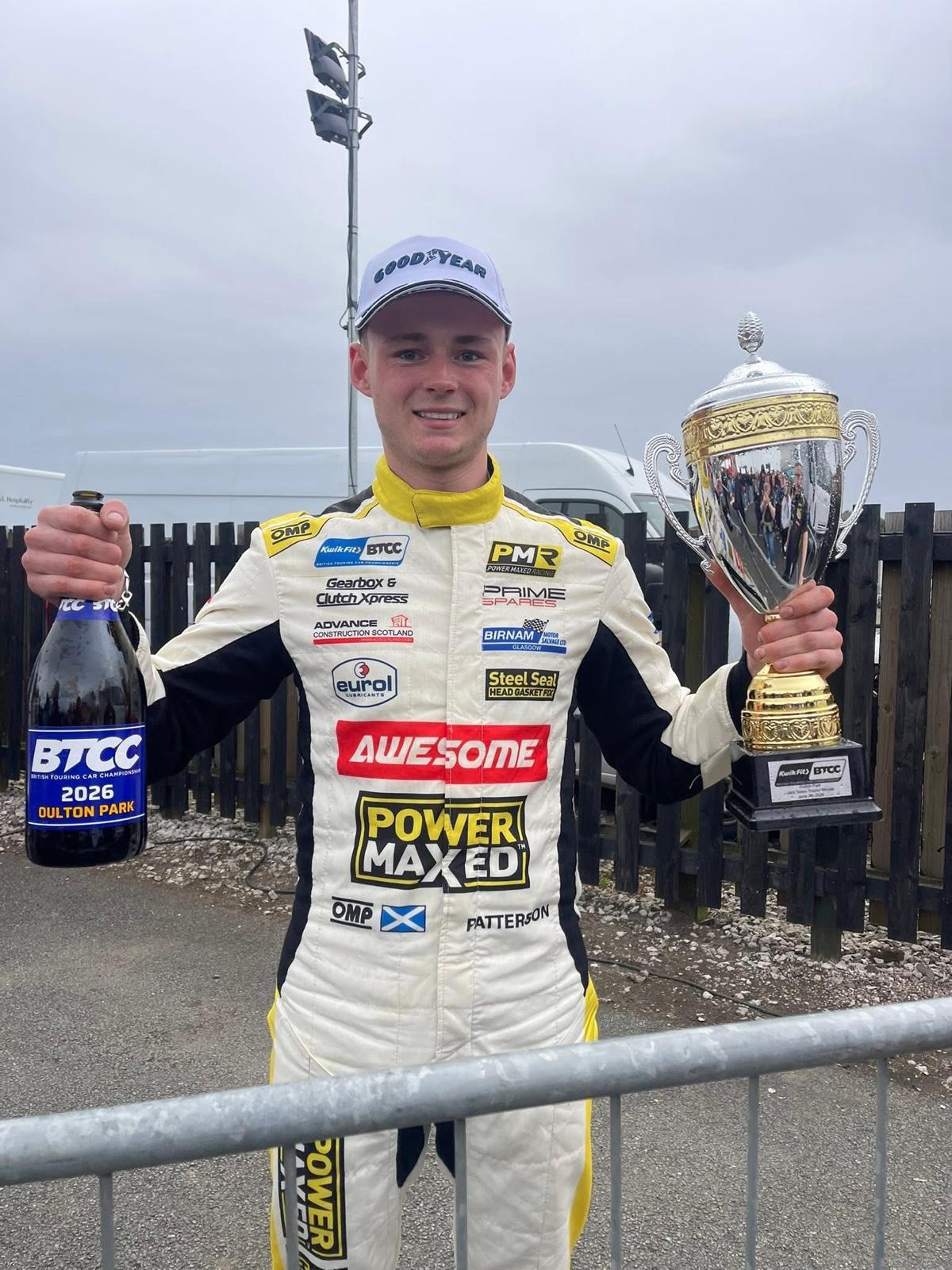 Dexter Patterson in his Awesome Power Maxed Racing race suit celebrating at Oulton Park with the Jack Sears Trophy and a BTCC 2026 Oulton Park champagne bottle